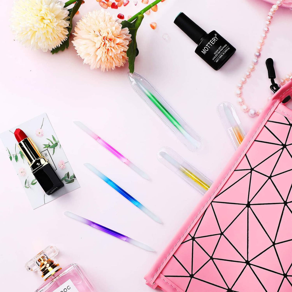 Colored glass cuticle pusher sticks on display, glossy etched nail pusher tips
