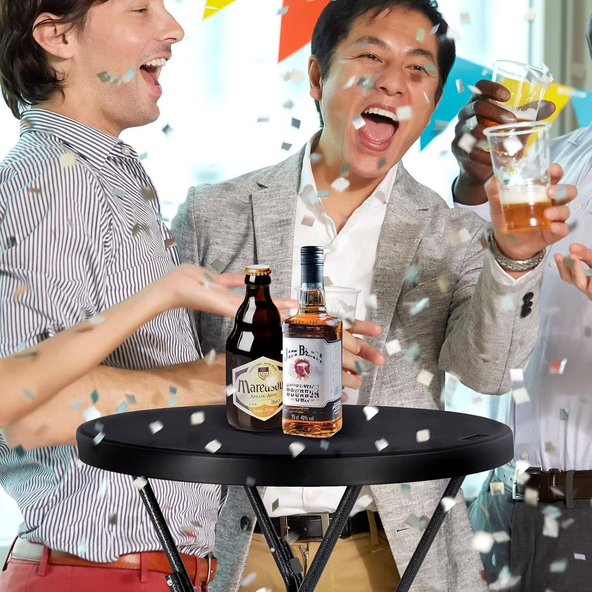 Round black cocktail table with drinks on top during a celebration