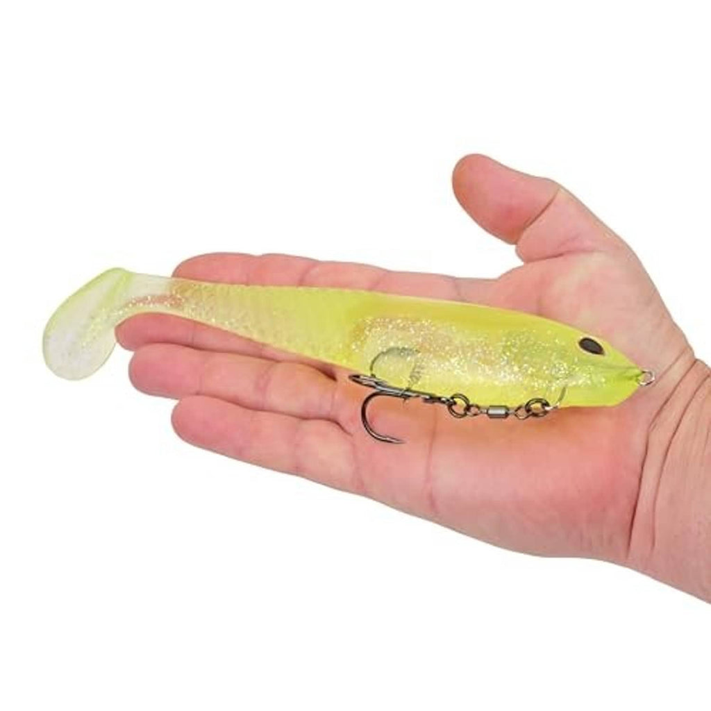 Lime ice swim bait in hand, translucent glitter body with black-eye and treble hook