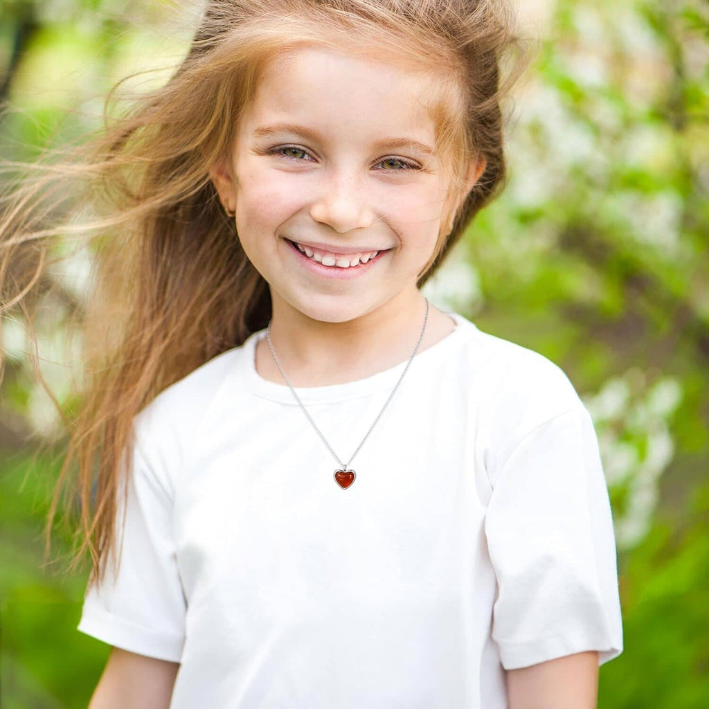 Heart pendant necklace with red carnelian stone on silver chain, worn