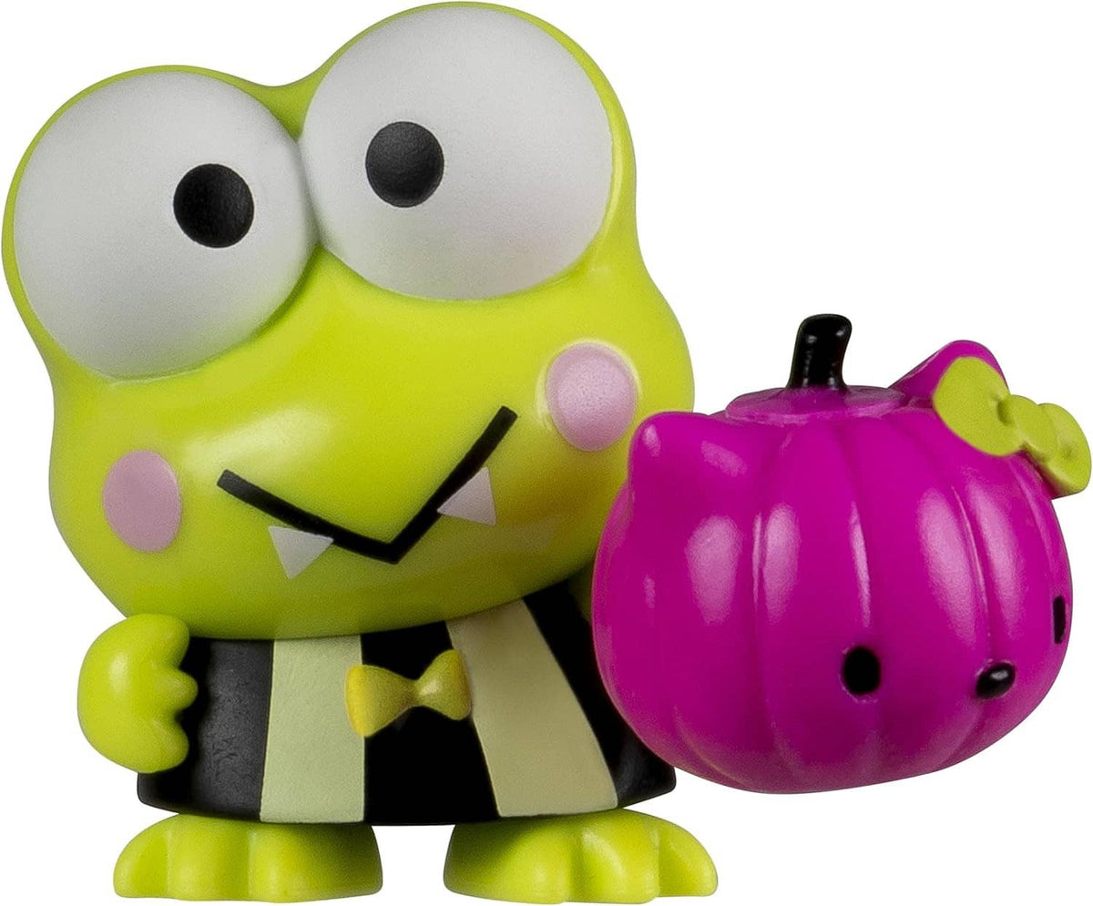 Green and white character figure holding a pink pumpkin accessory