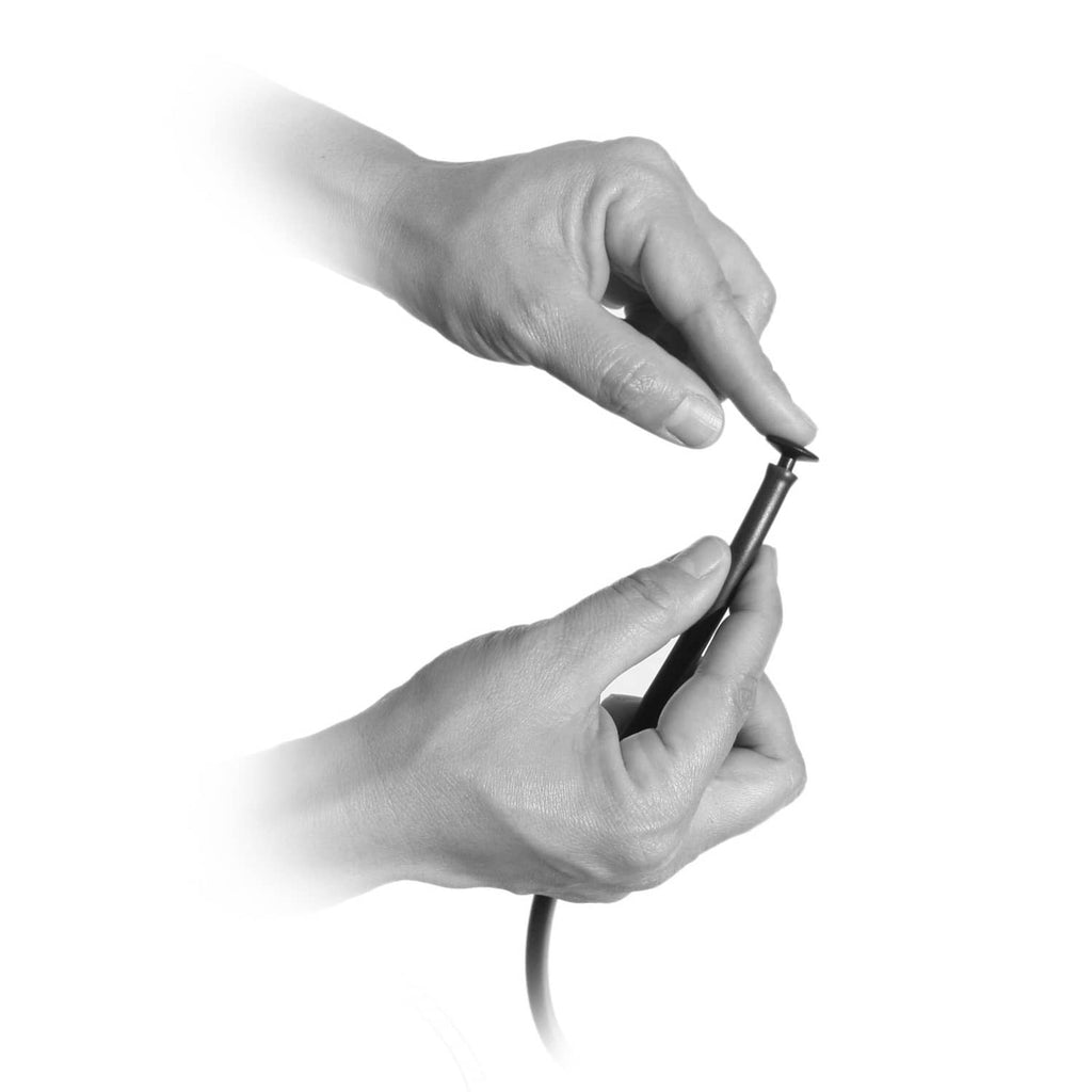 Hands installing a black goof plug on drip irrigation tubing