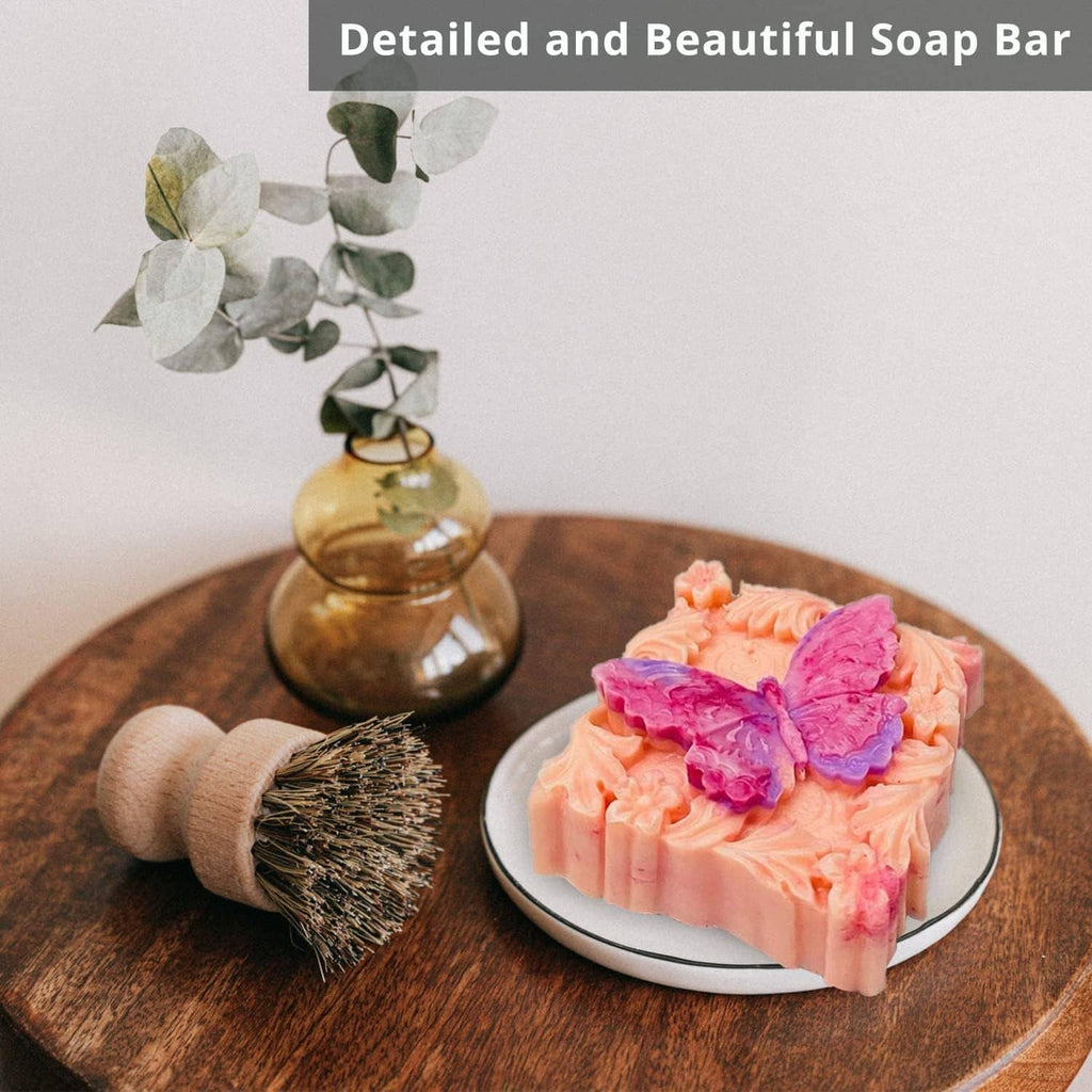 3D floral butterfly soap bars on a plate, with a small scrub brush nearby