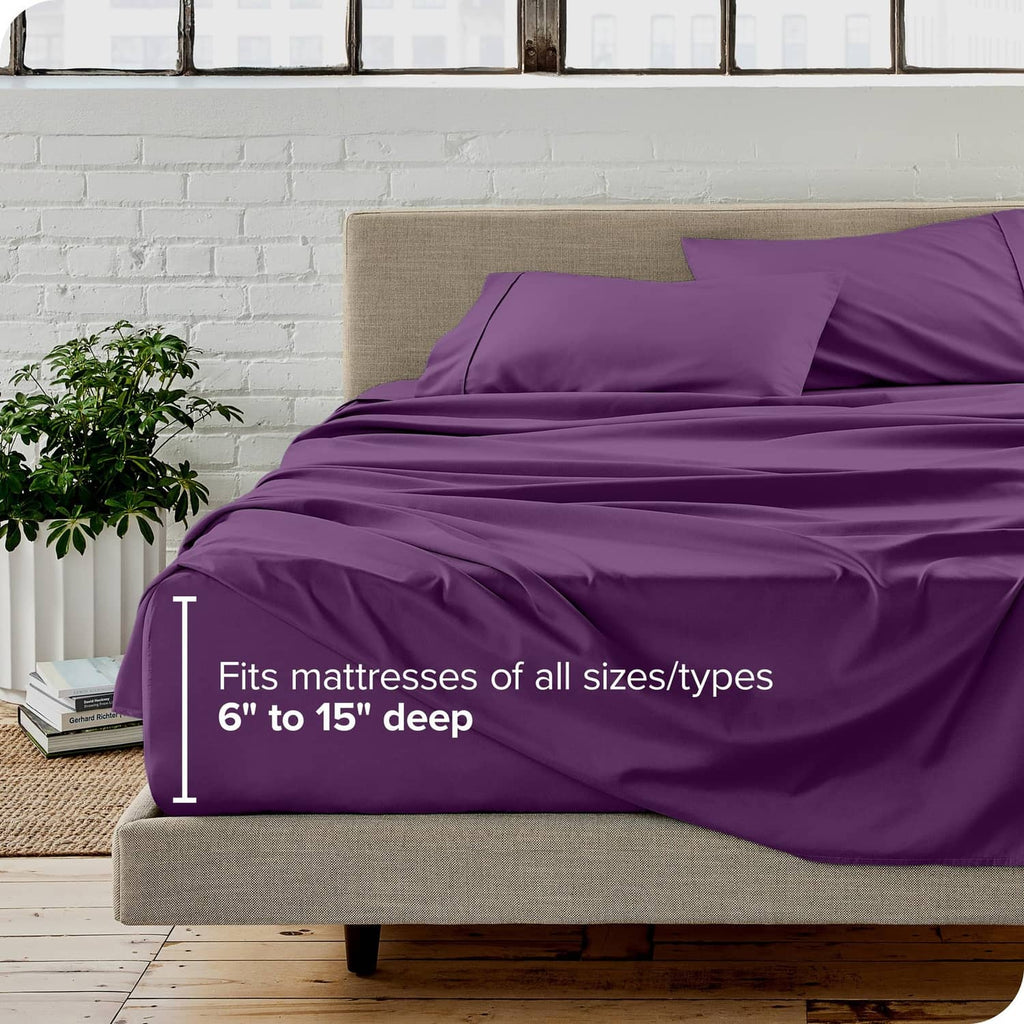 Plum twin bed sheet set with fitted sheet and pillowcases on a neutral bed