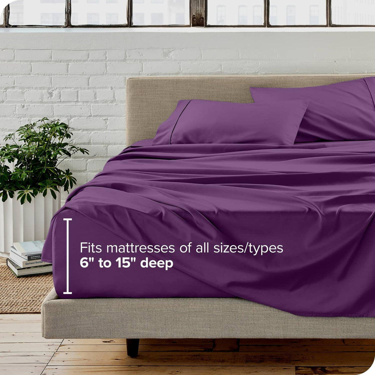 Plum twin bed sheet set with fitted sheet and pillowcases on a neutral bed