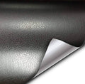 Black fine-grain leather wrap adhesive vinyl sheet with peeled backing corner
