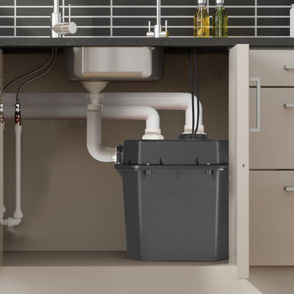 Utility sink drain pump installed under cabinet with drain and supply line connections