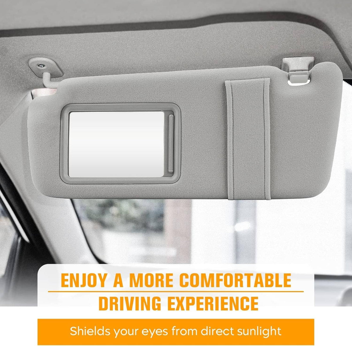 Gray sun visor with rectangular mirror opening and pull tab, close-up
