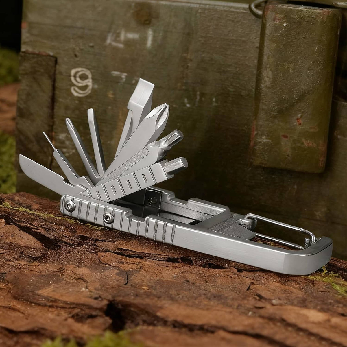 Stainless steel multi-tool opened on an outdoor surface with key ring and bit tools