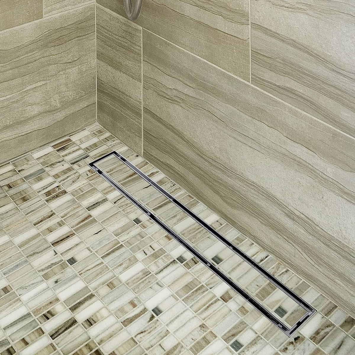 Linear shower drain insert with dark grate installed in a tiled shower floor