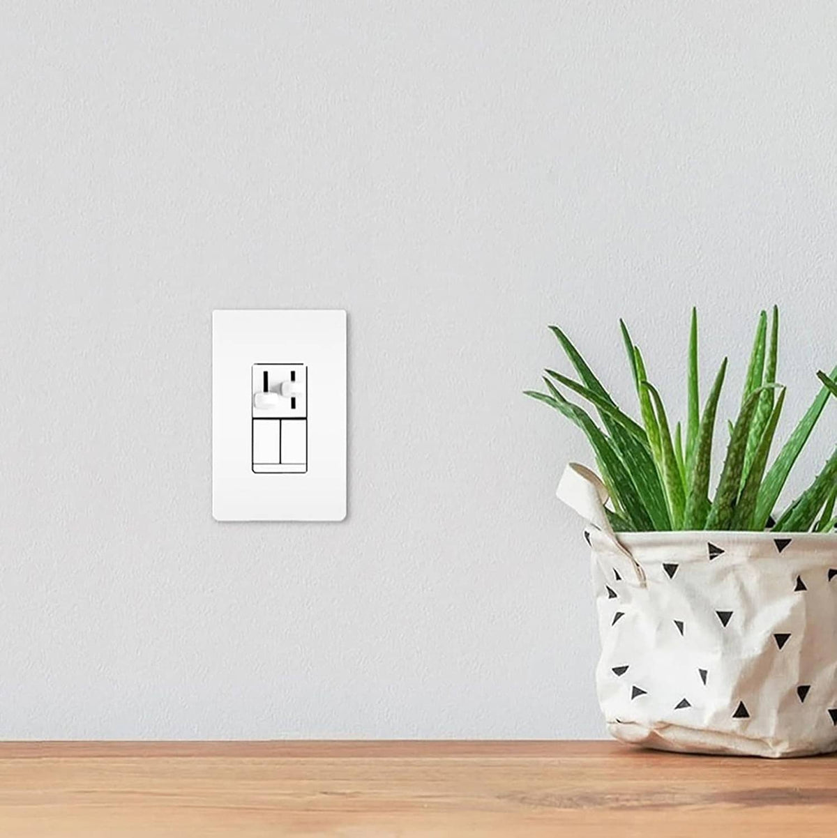 White wall dimmer switch with small icon markings on a light wall