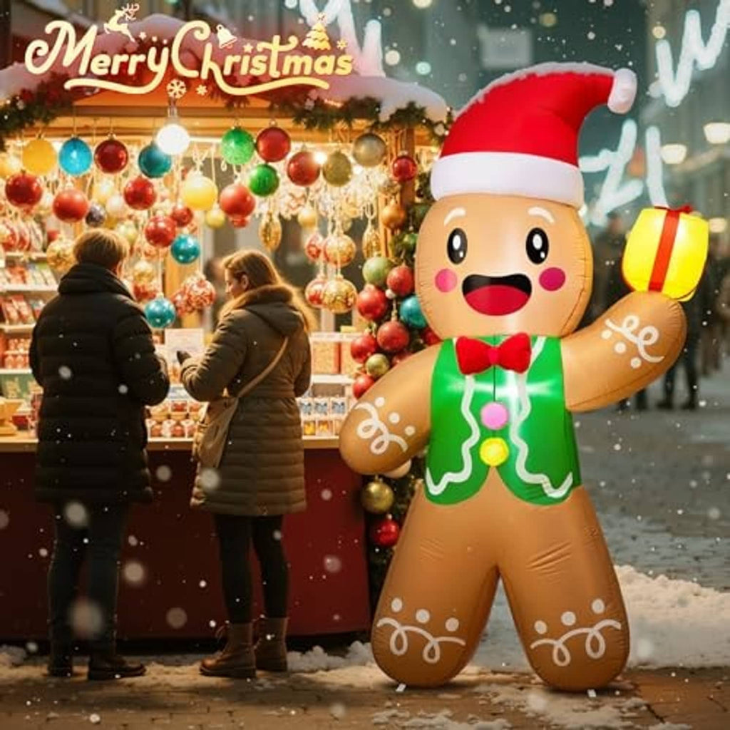 Gingerbread man inflatable in red Santa hat and green icing, smiling and waving a yellow lantern
