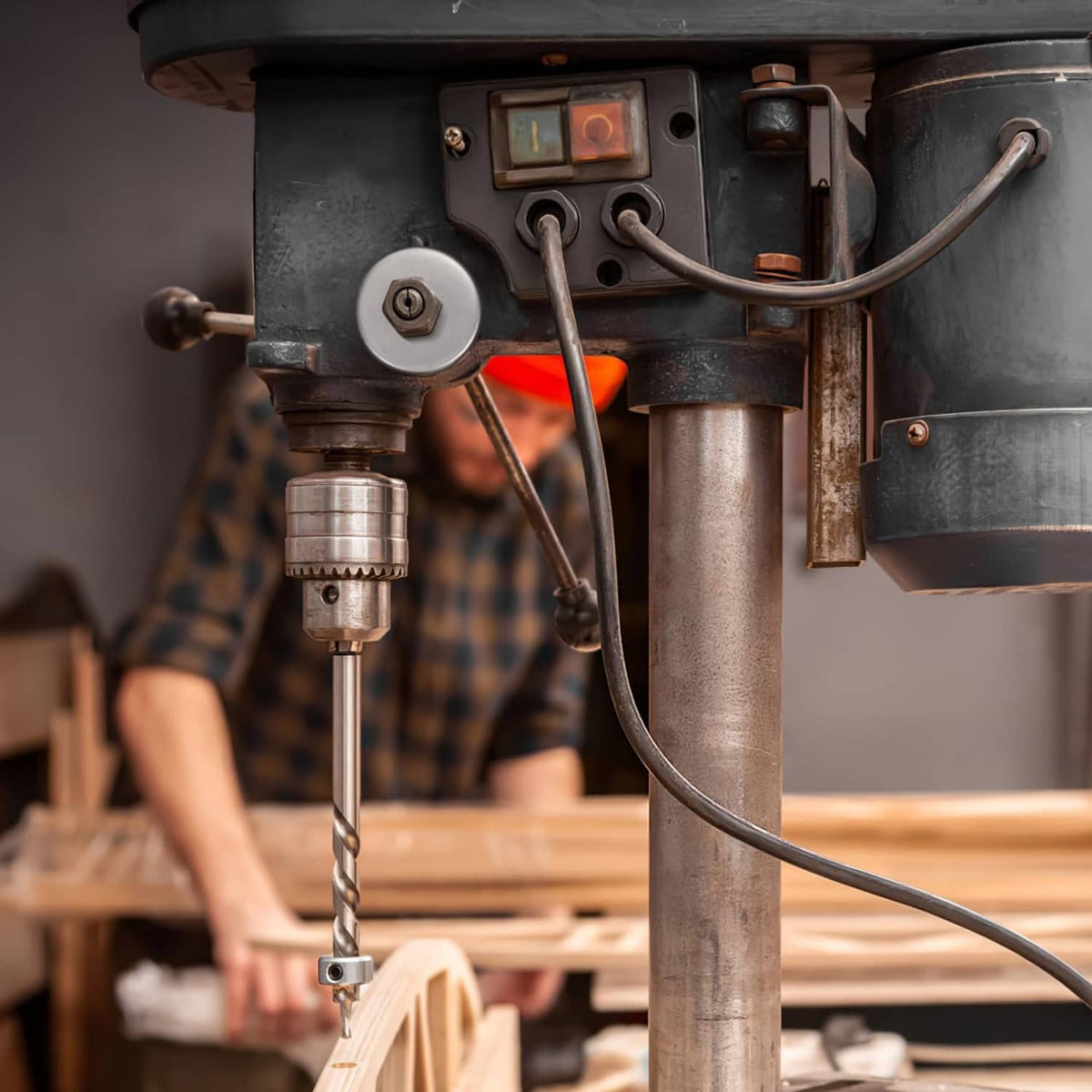 Drill press return spring assembly mounted near the spindle support