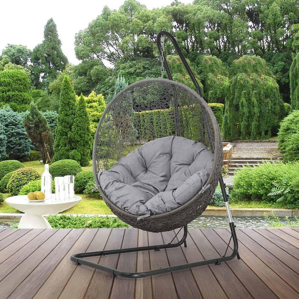 Black metal hammock chair stand with hanging round net seat and padded cushion