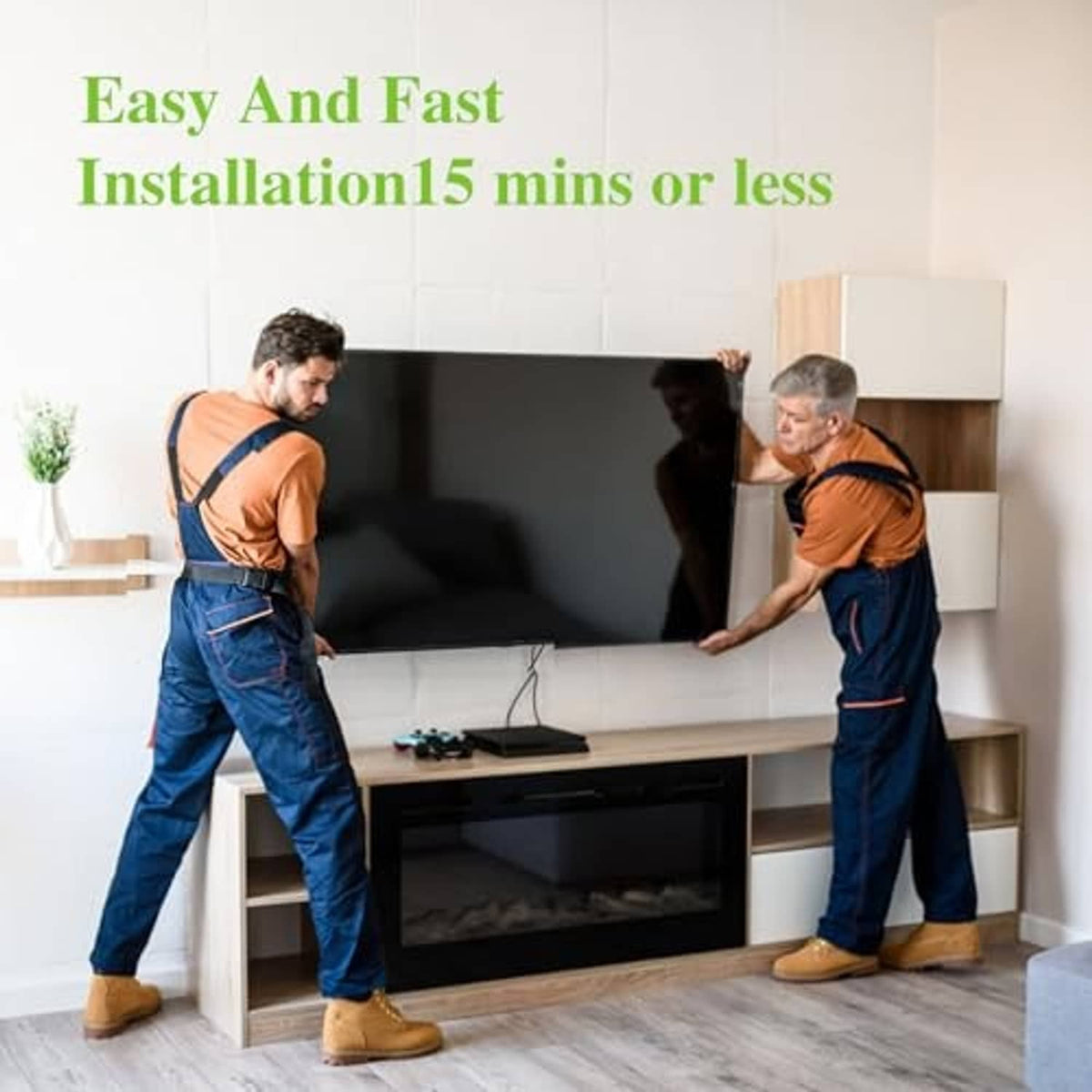 Two installers holding a TV mounted on an articulating wall bracket