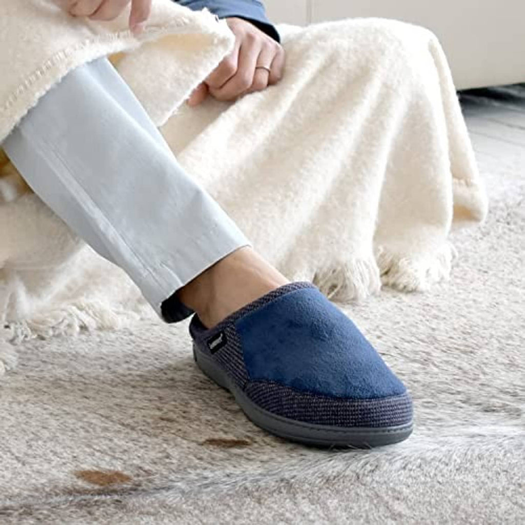 Men's navy slip-on slipper with padded collar, worn with light pants