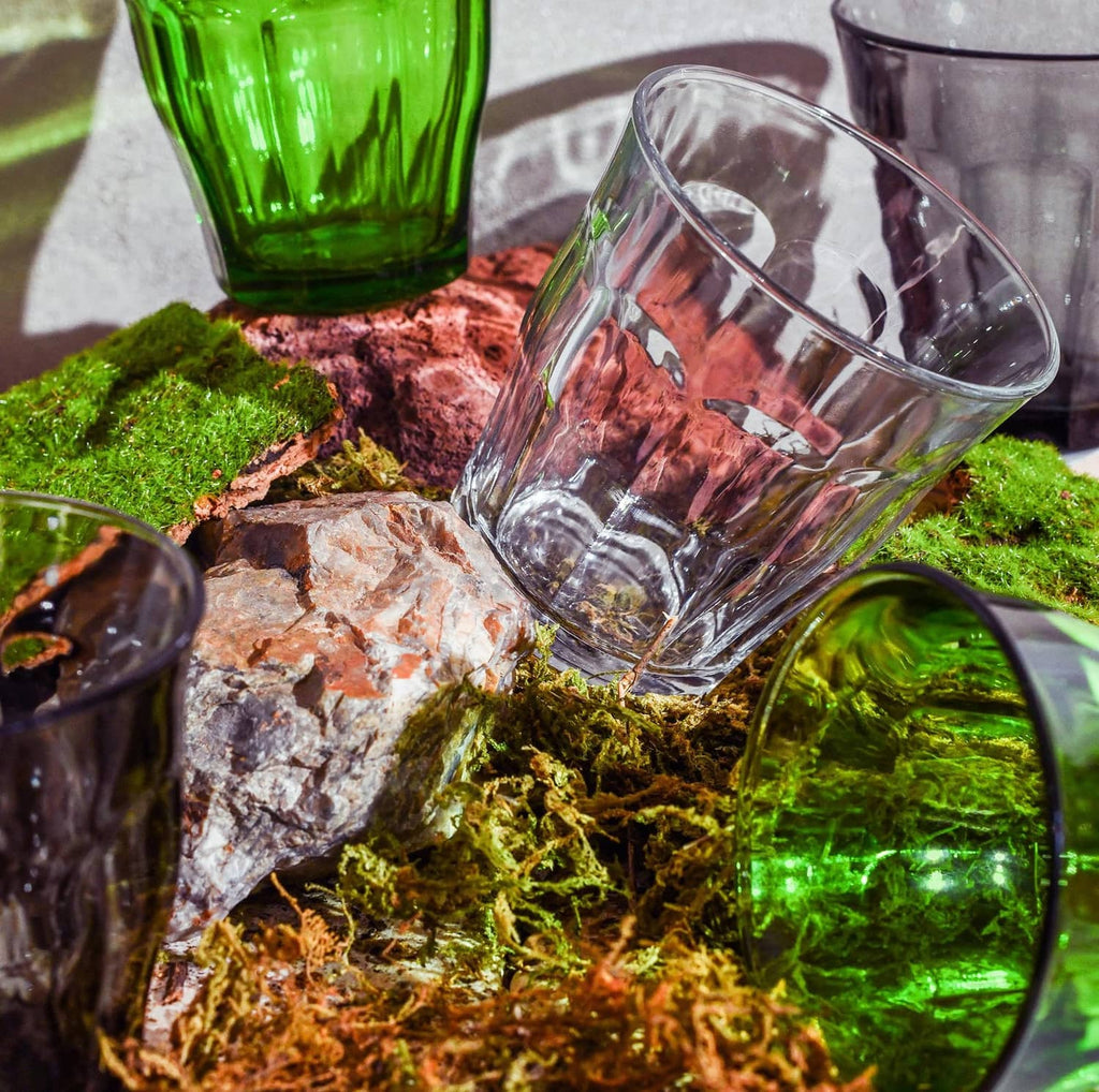 Clear glass tumbler tilted in a decorative setting