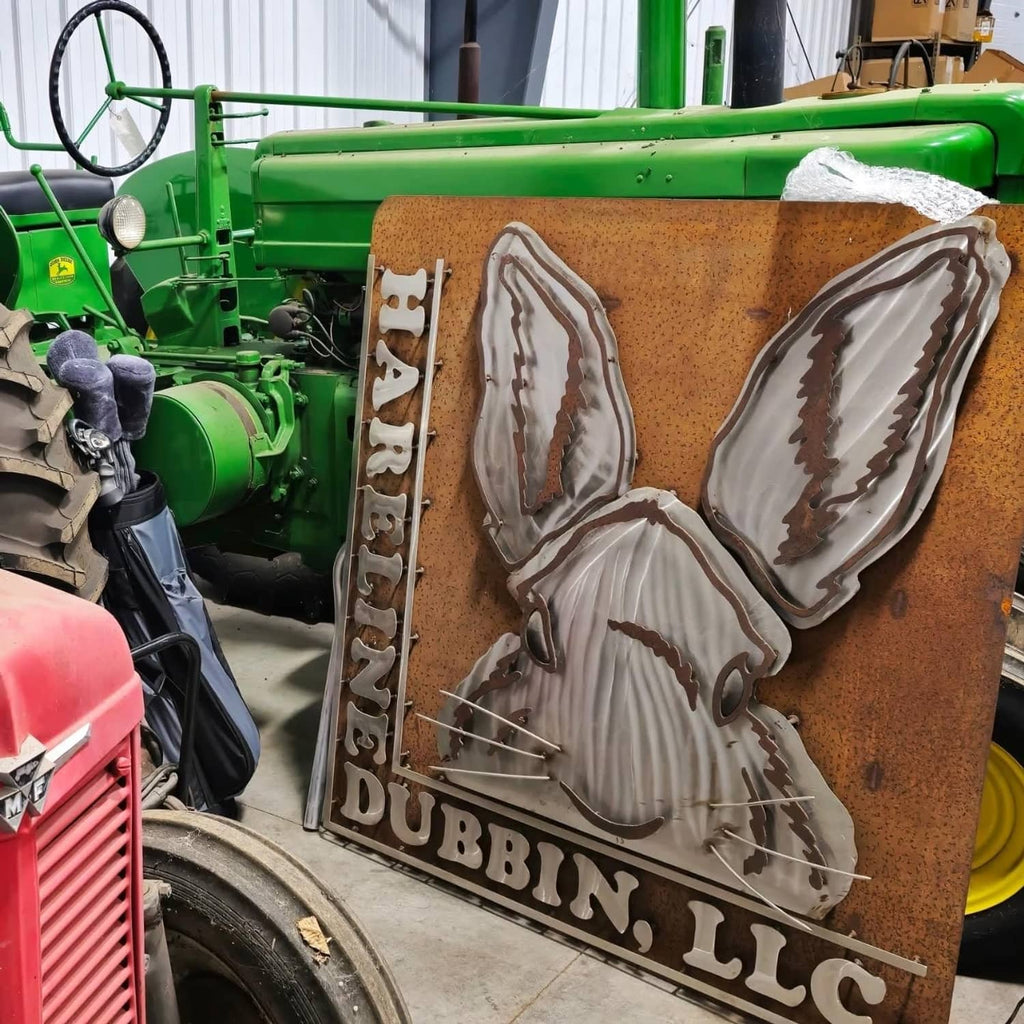Feather-shaped display patch on a brown board with "DUBBIN' LLC" text