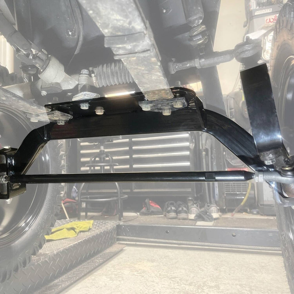 Under vehicle view showing installed lift kit hardware near front axle