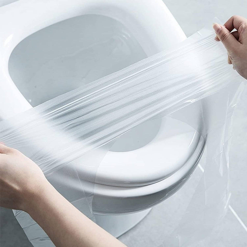 Waterproof disposable toilet seat cover stretched over a white toilet seat