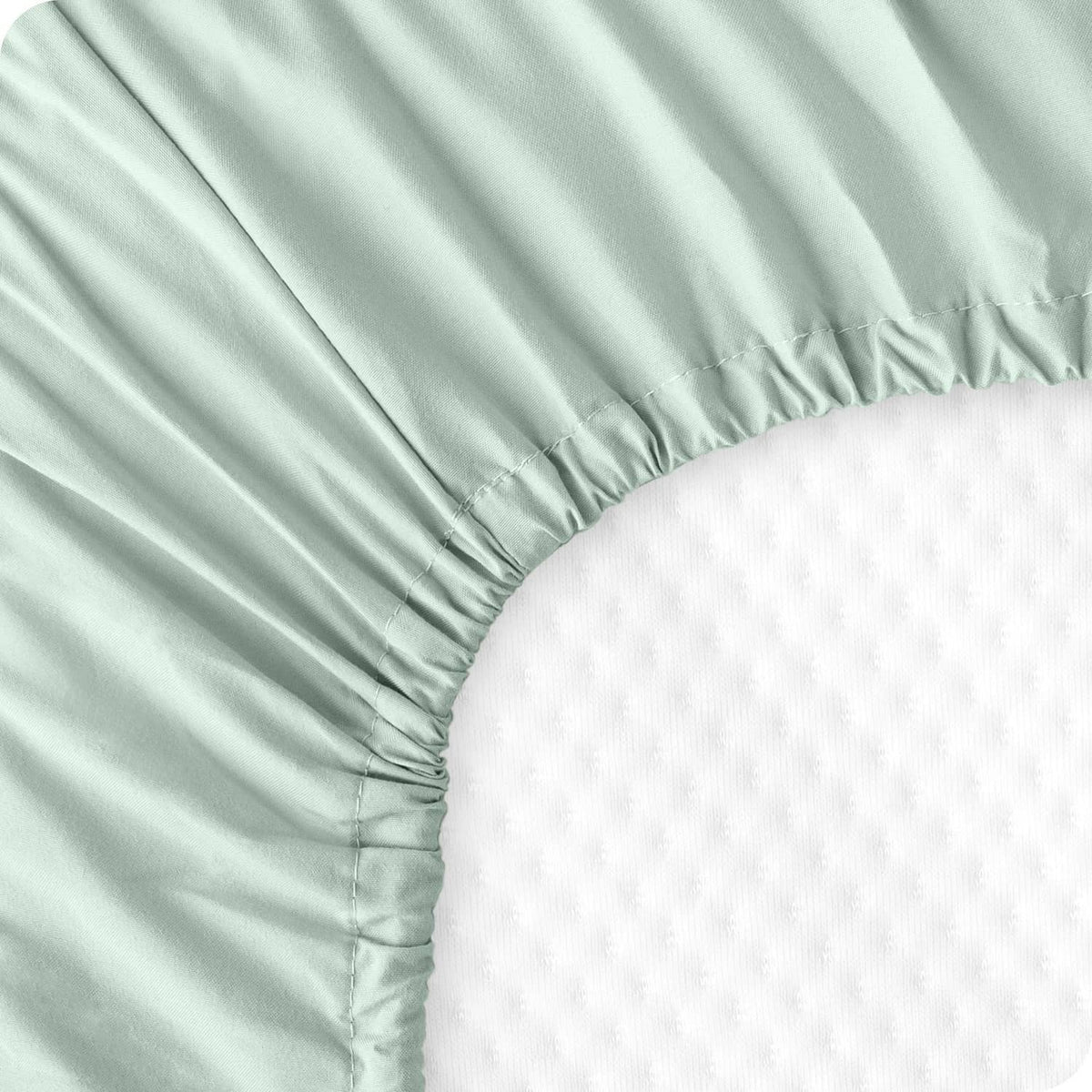 Mint green fitted sheet corner with elastic gathers and smooth microfiber