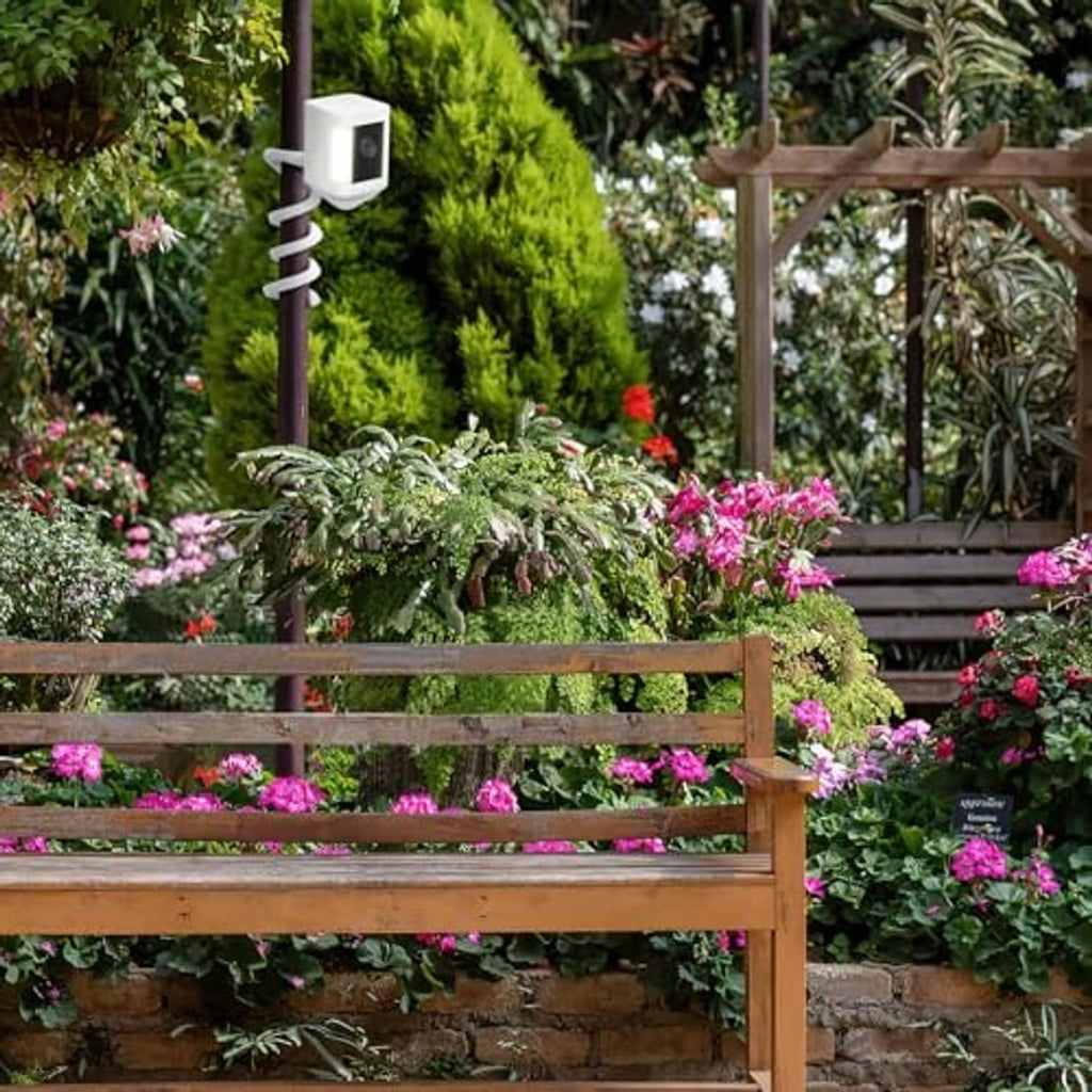 White twist mount installed on an outdoor fence post for a security camera