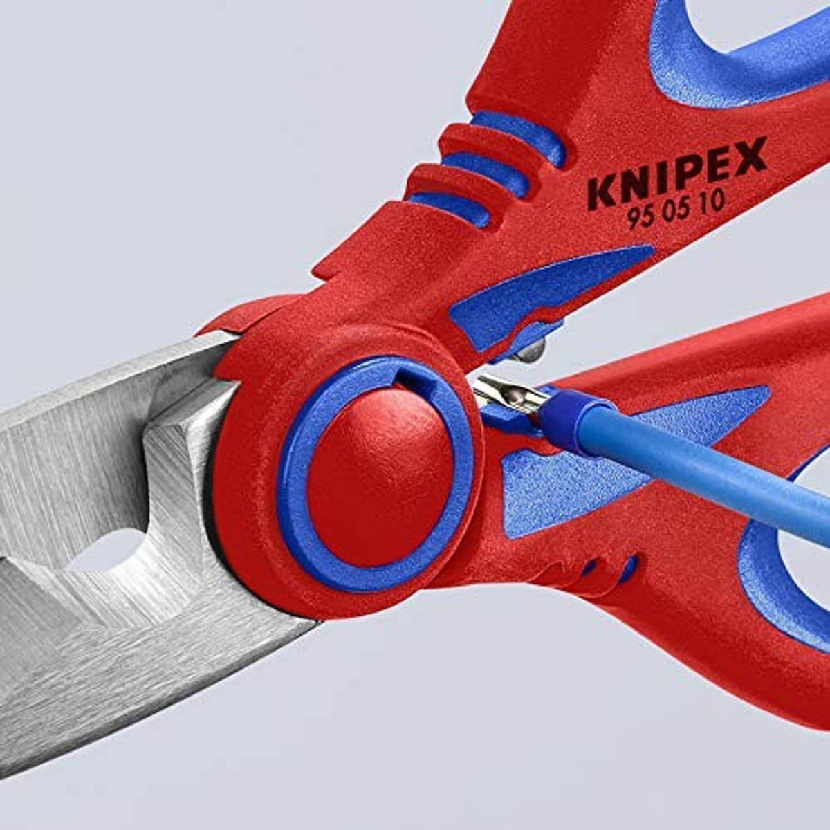 Electricians' shears jaw and pivot close-up, red handles with KNIPEX branding and blue linkage