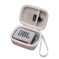 Sand-colored zippered speaker case with wrist strap, open view showing a JBL speaker