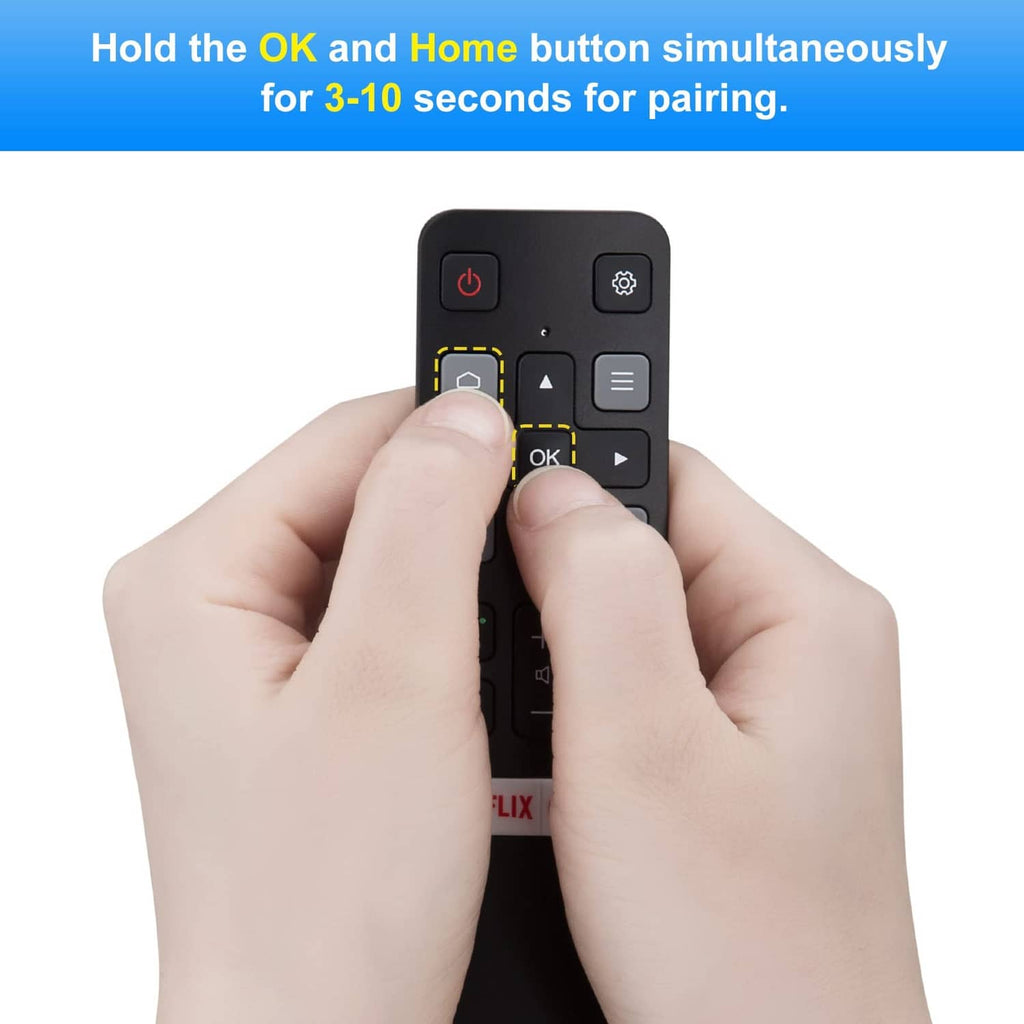 Black voice remote with a thumb pressing the OK button for pairing