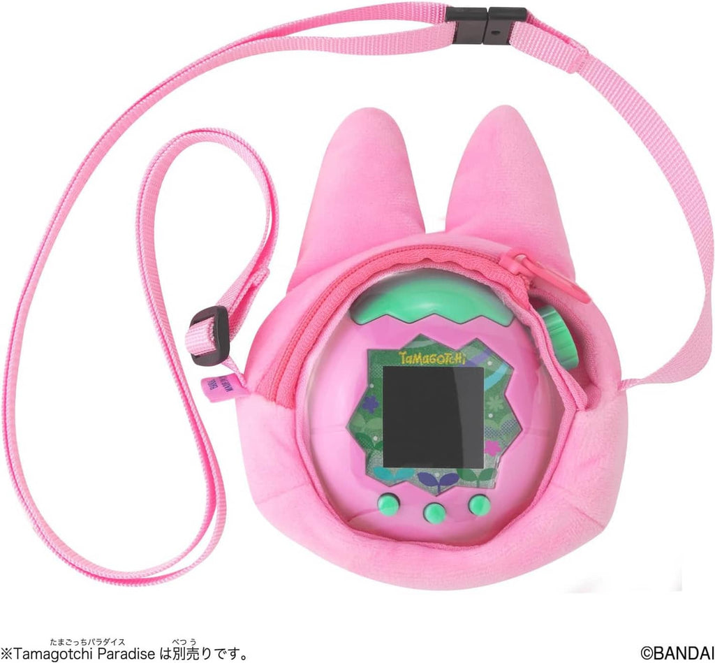 Pink plush bunny carrier with open pocket revealing green-screen Tamagotchi device