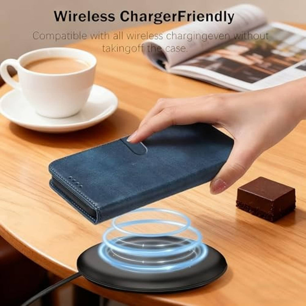 Blue wallet phone case flat on a desk with wireless charging pad nearby