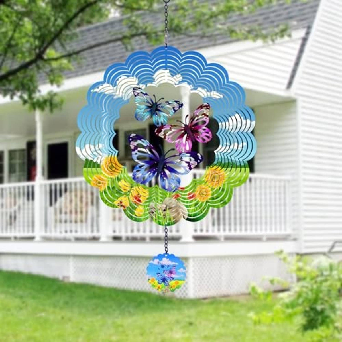 Butterfly wind spinner hanging in garden with blue-green scalloped metal and butterfly cutouts