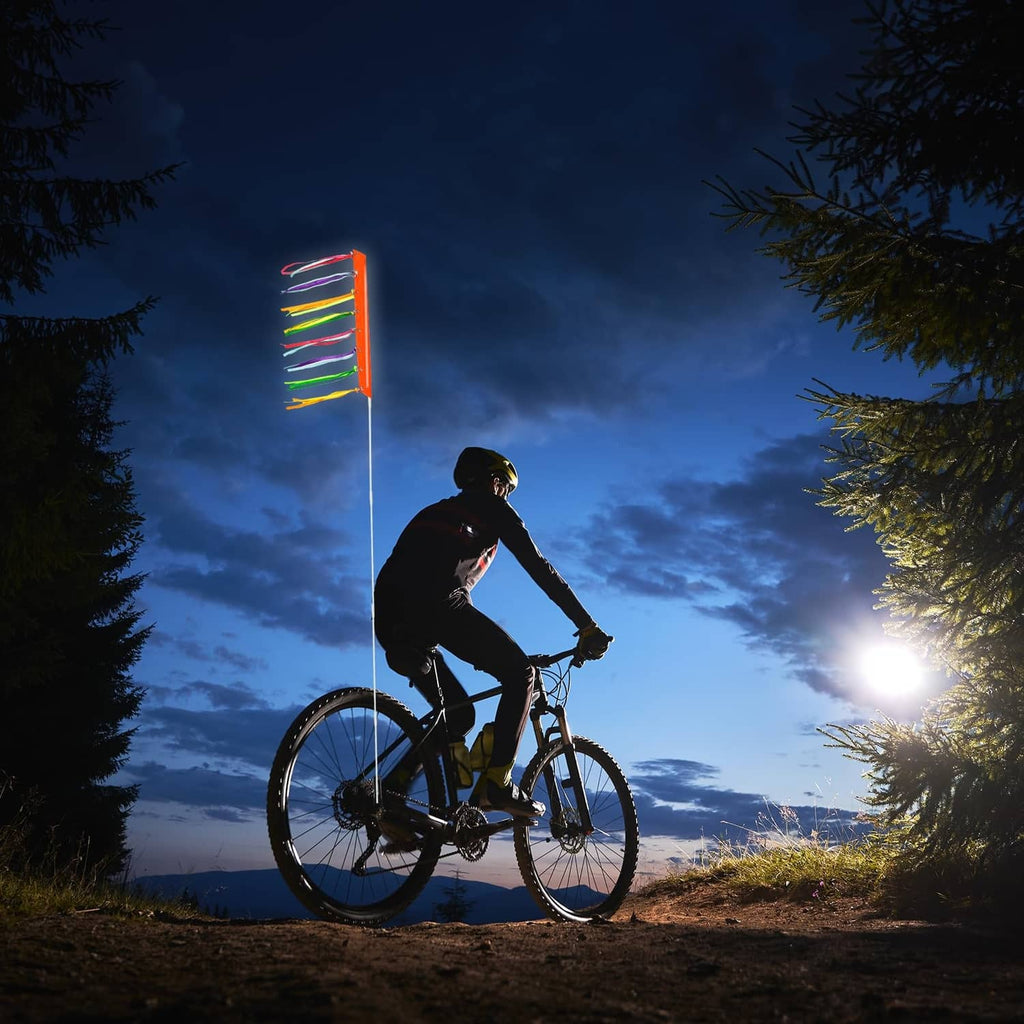 Bike safety flag on a tall white pole with multicolor ribbon tails