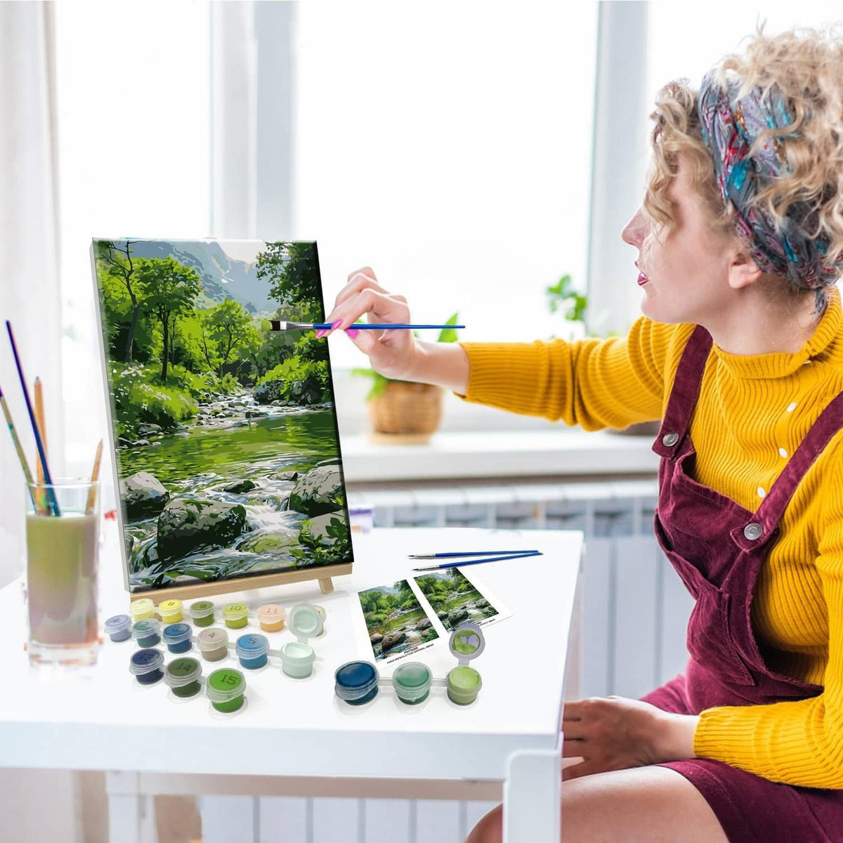 Adult painting landscape paint-by-number canvas with brush and color pots