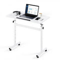 Adjustable height standing desk with tilting desktop, white frame, and caster wheels