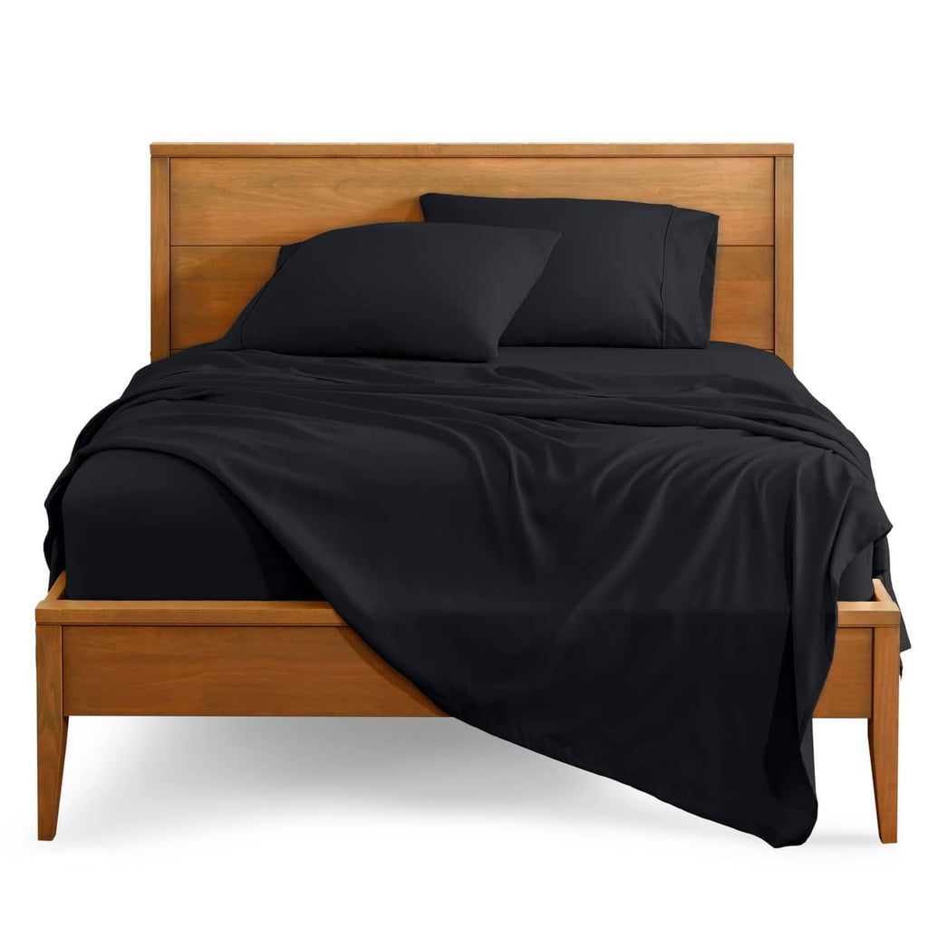 Black split California king bed sheet set, fitted sheets and pillowcases on bed
