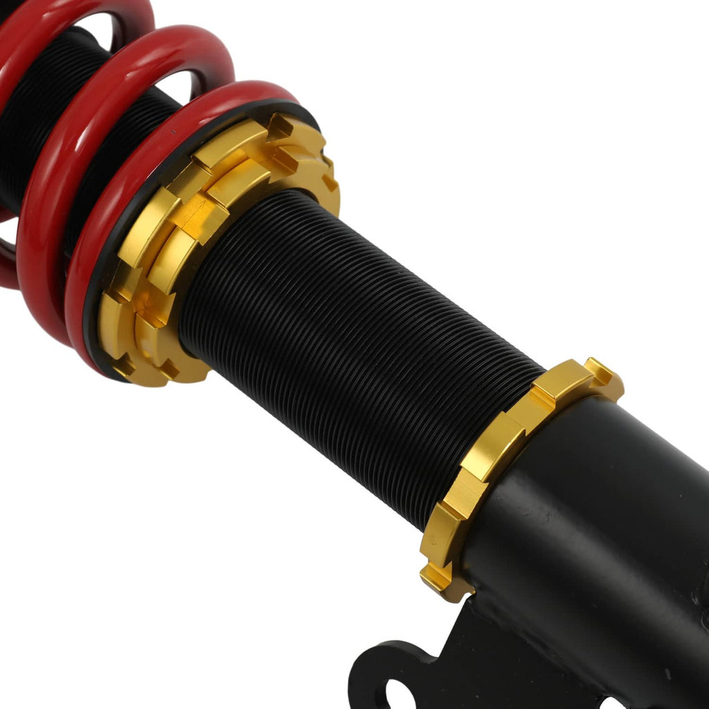 Coilover shock absorber with red spring and gold adjustment collar