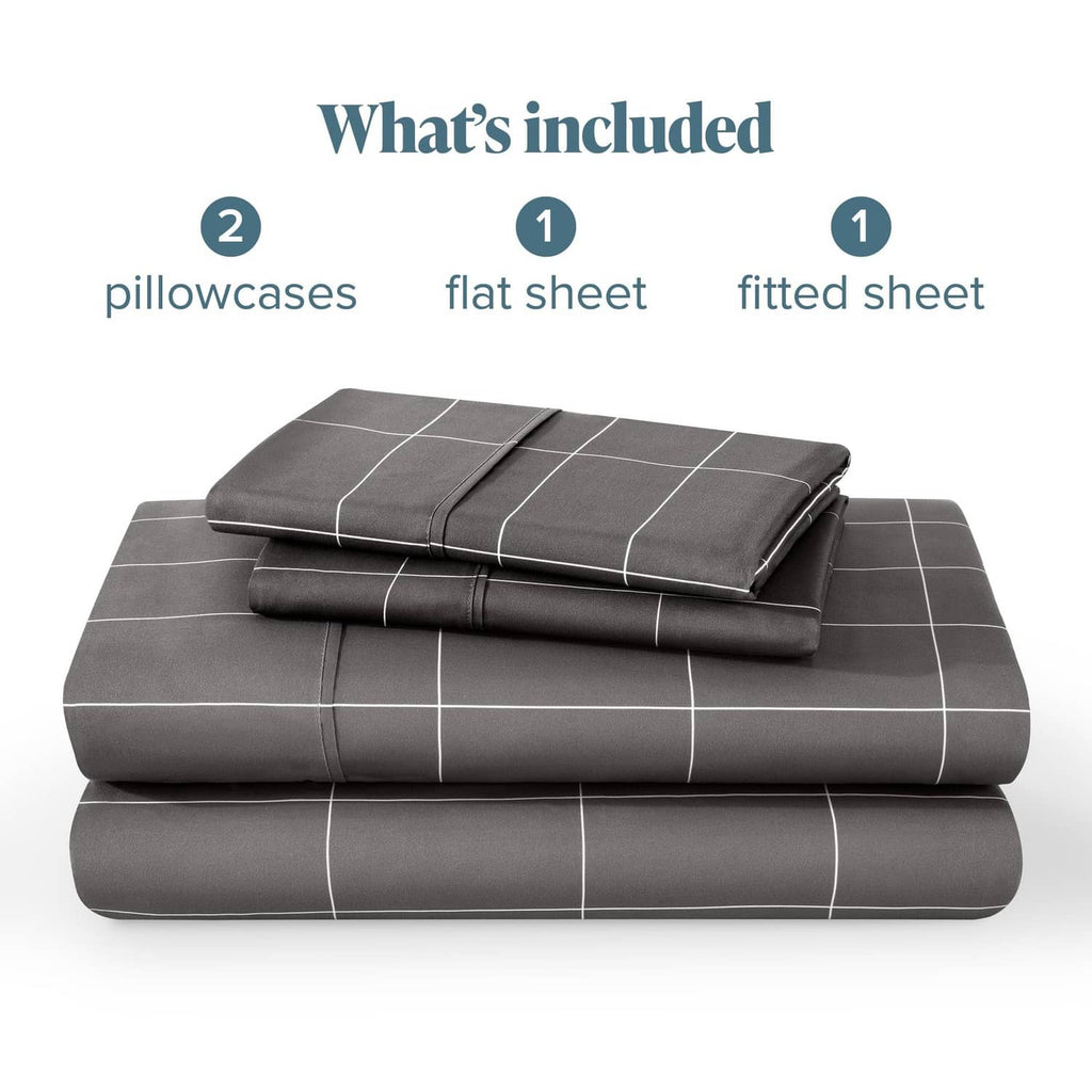 Folded grey bed sheet set with white grid, including fitted sheet and two pillowcases