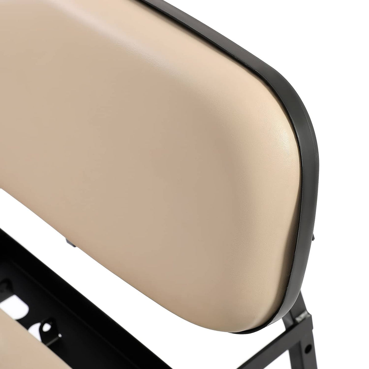 Close-up of tan seat back cushion with black edge trim and mounting hardware