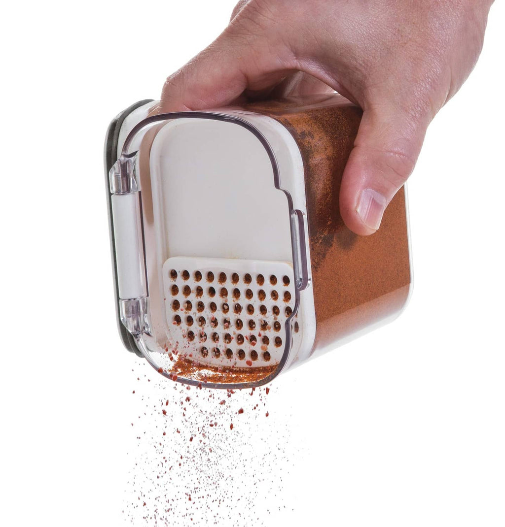 Mini airtight container with white lid and grater insert; spices falling out