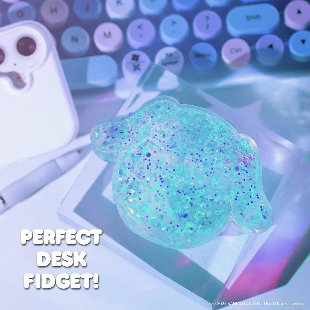 Blue glitter gel slime shaped like a bear, on a desk with keyboard