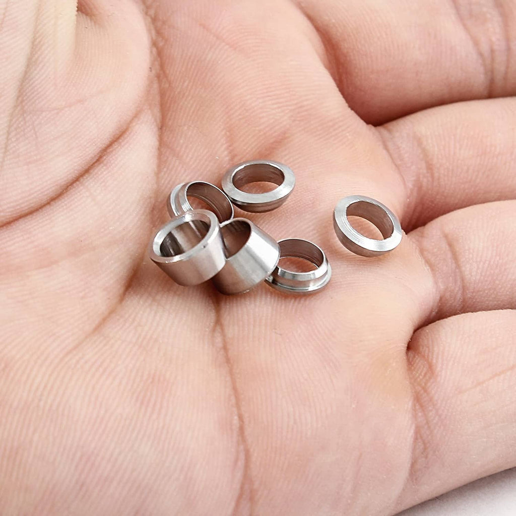 Small stainless steel ferrule sleeves held in hand, reflective ring openings