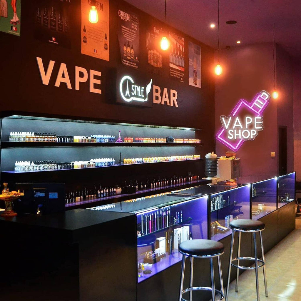 Neon VAPE SHOP sign with pink outline arrow and white letters for vape bar display