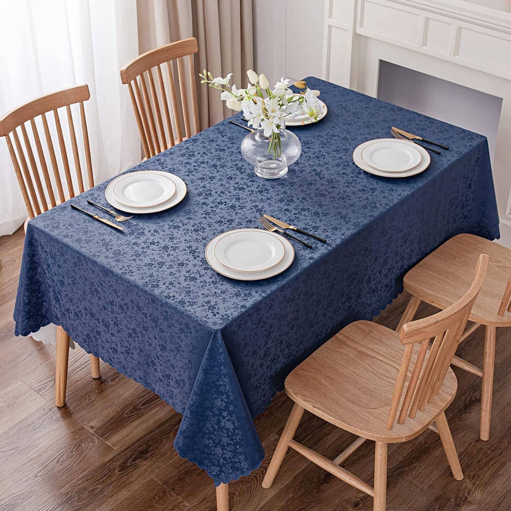 Blue floral vinyl tablecloth on dining table with plates, cutlery, and chairs