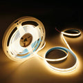 Warm white LED strip coils with exposed wire leads and glowing strips.