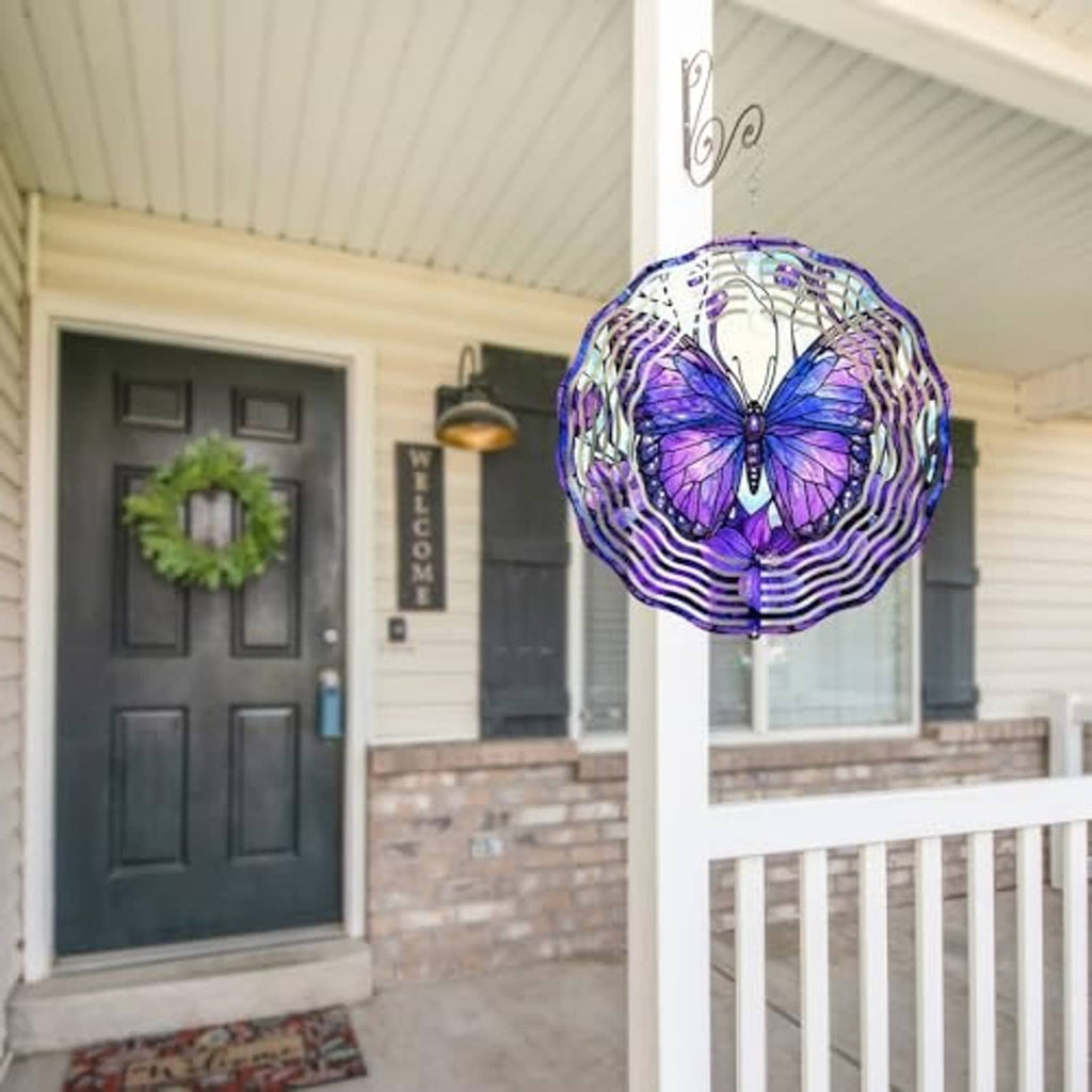 Purple butterfly wind spinner with white spiral rings hanging near porch ceiling