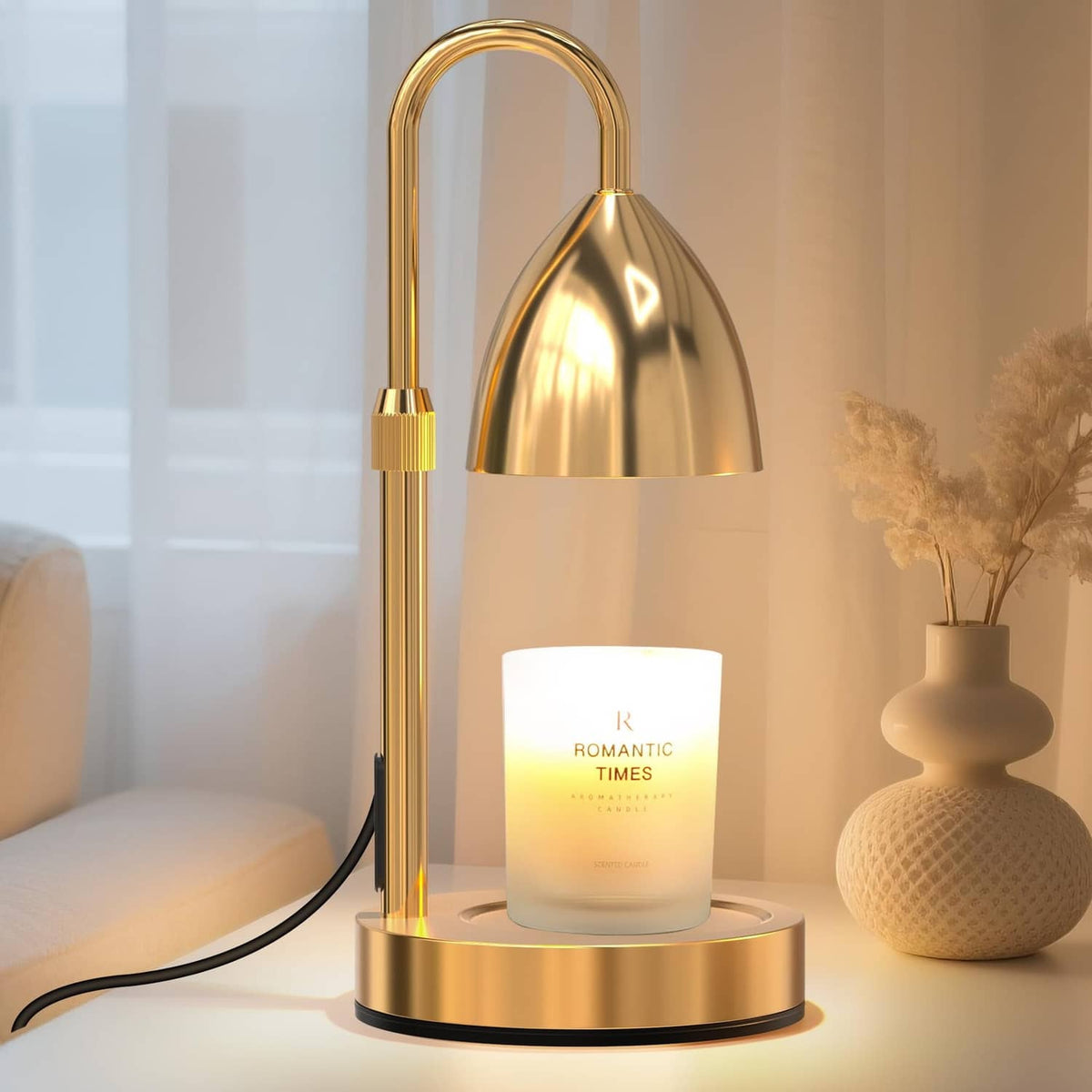 Gold candle warmer lamp with arched handle and reflective metal shade on round base stand