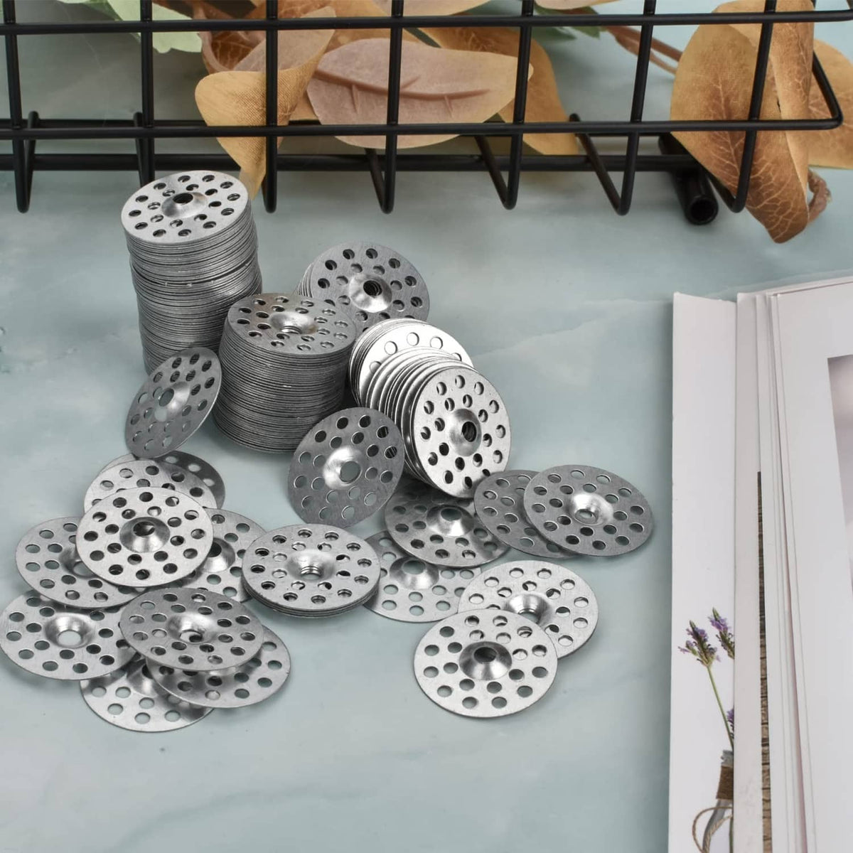 Assorted stacks of round metal plaster washers with small holes and center openings
