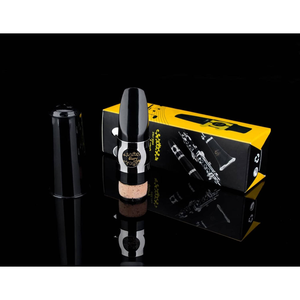 Clarinet mouthpiece kit with black mouthpiece, silver ligature, cork reed, and yellow box