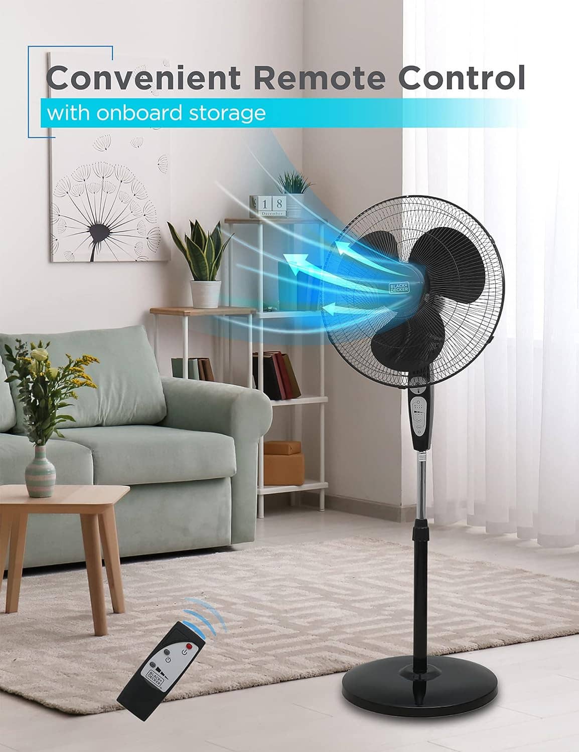 Black pedestal stand fan with remote control, airflow direction indicator